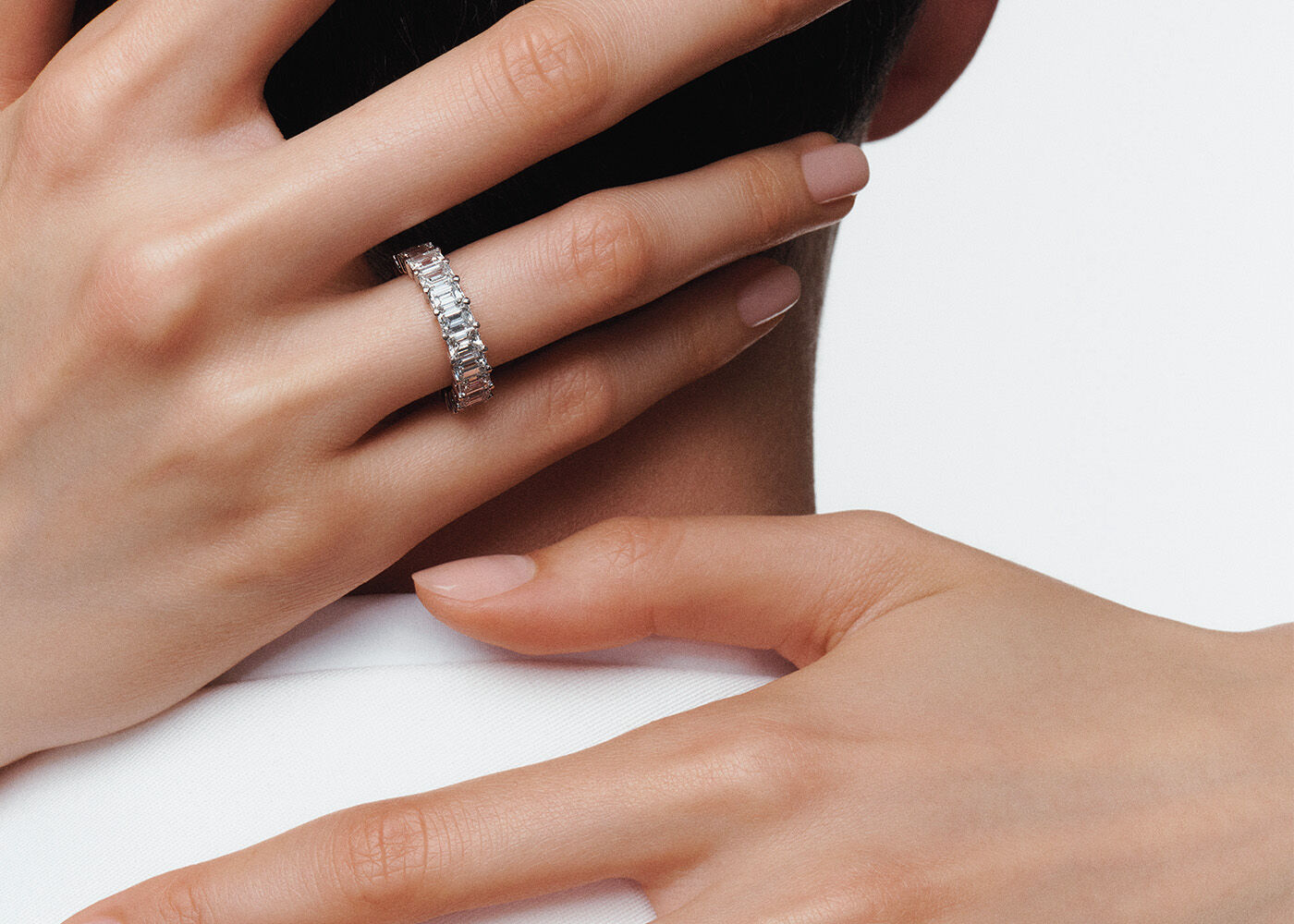 Eternity Bands - Image shows model wearing Graff Emerald Cut White Diamond Eternity band