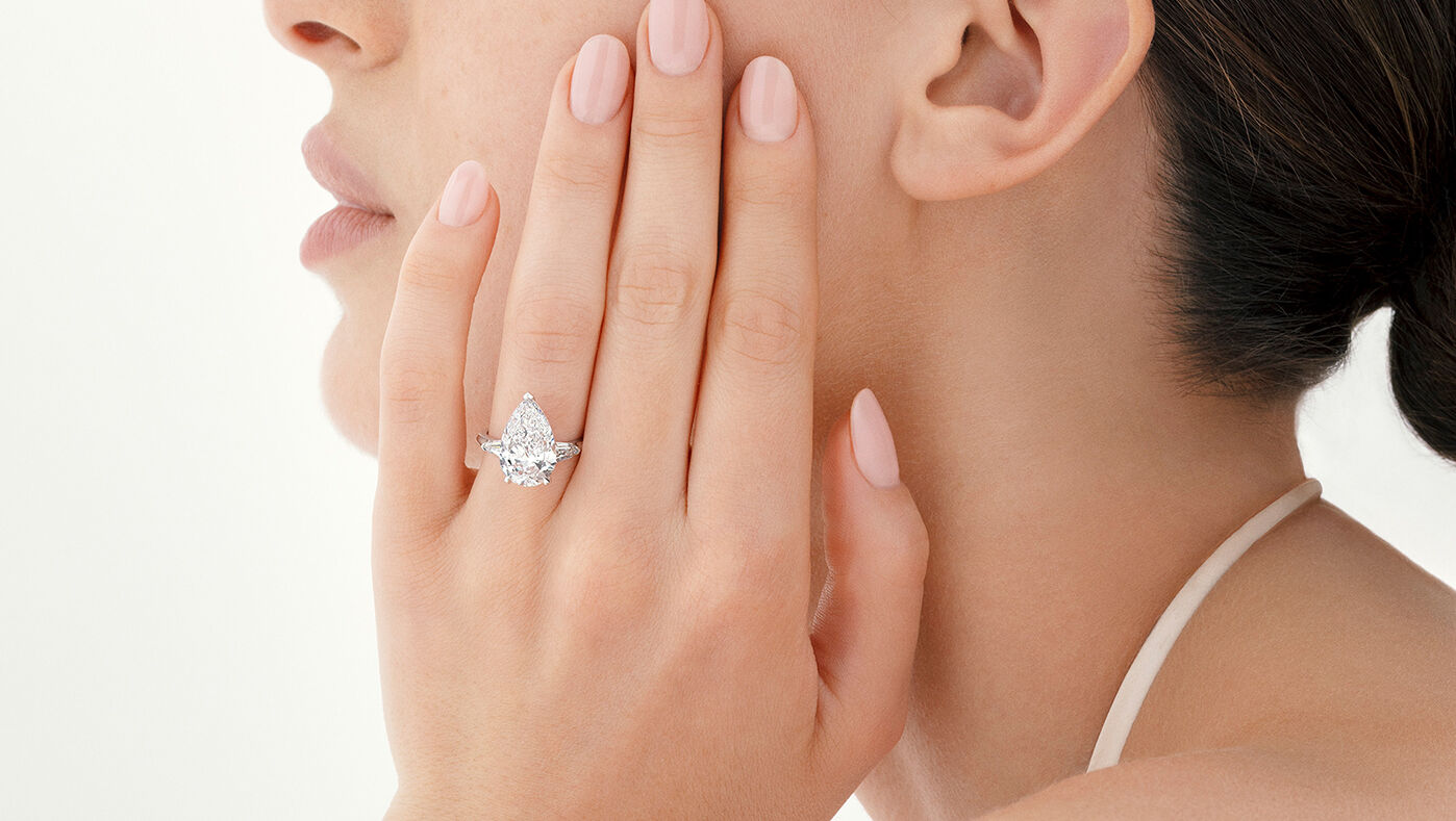 Engagement rings - model wears Graff Pear Shape diamond engagement ring