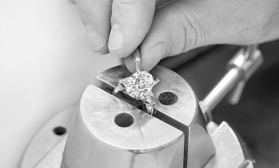 Bridal Guides. Graff craftsman setting diamond in Graff Promise Setting Diamond Engagement Ring in workshop
