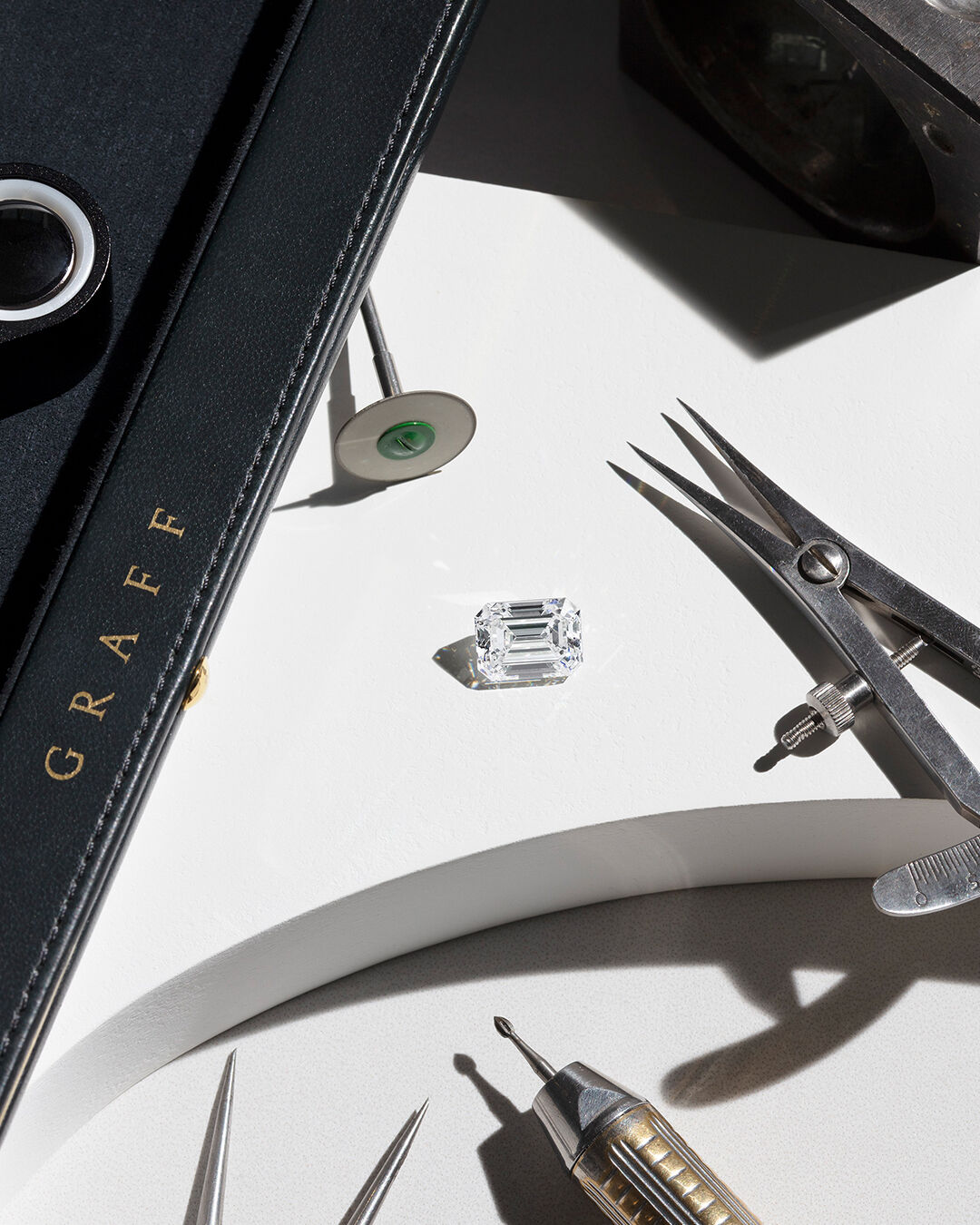 Laurence Graff OBE inspecting heart shape diamond through loupe