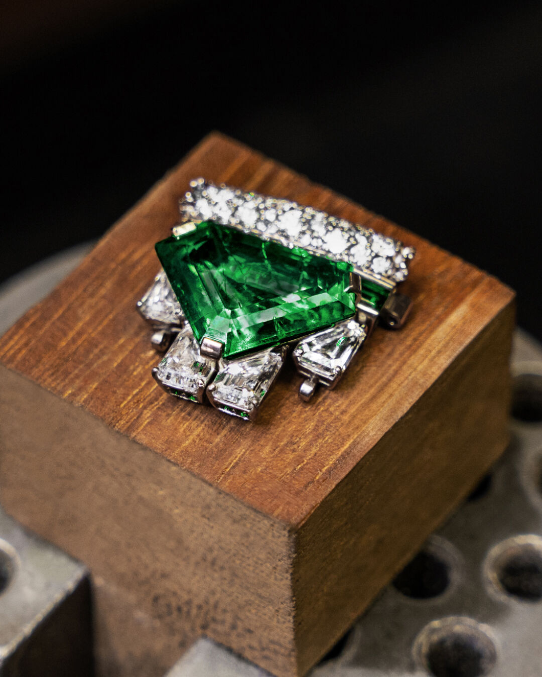 Image shows Graff Emerald and White Diamond High Jewellery bangle being created in Graff workshop