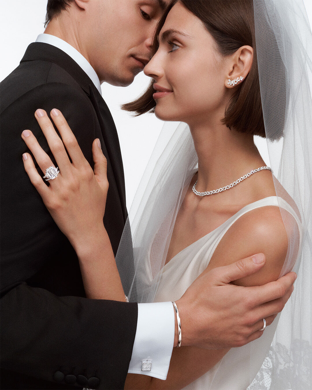 Couples' Rings - image shows couple wearing Graff Couples Wedding Rings and other Graff bridal jewellery