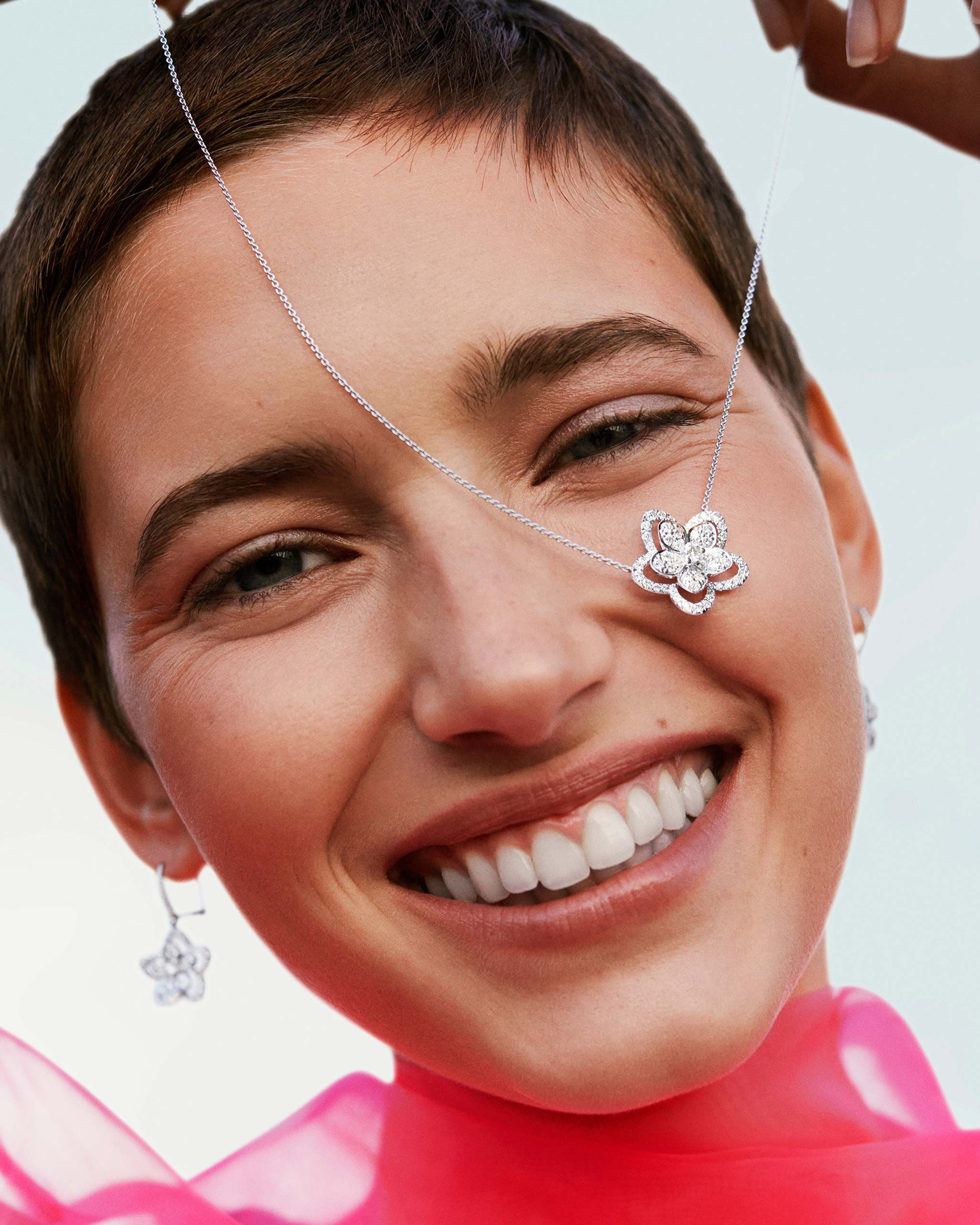Close up of a model wearing the Graff Wild Flower jewellery collection diamond earrings & pendant