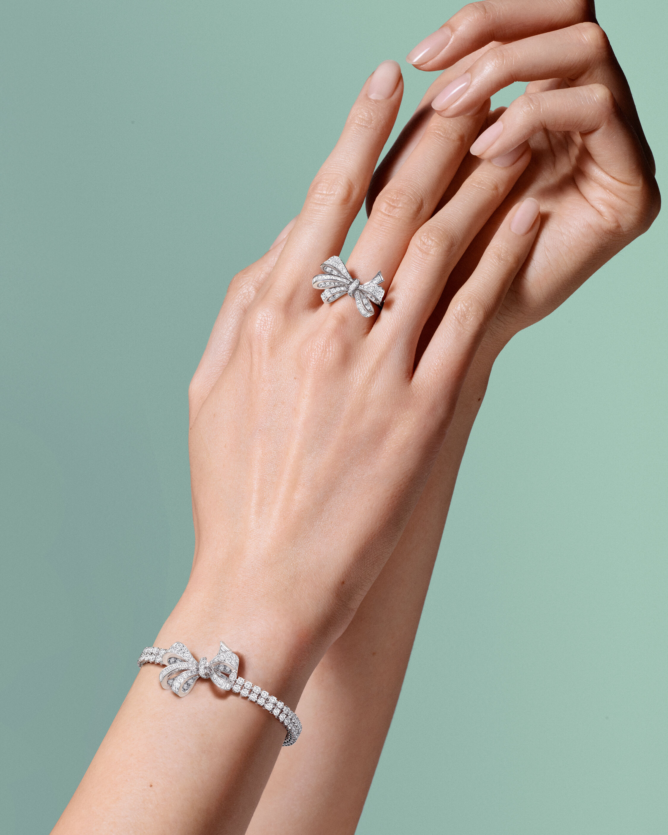 Image of model hands wearing Graff Tilda's Bow ring and bracelet 