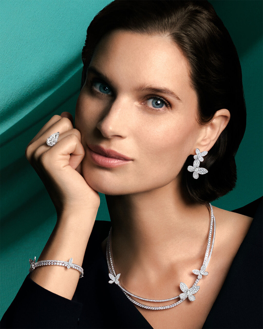 Image shows model wearing Graff Butterfly Pave Diamond jewellery suite