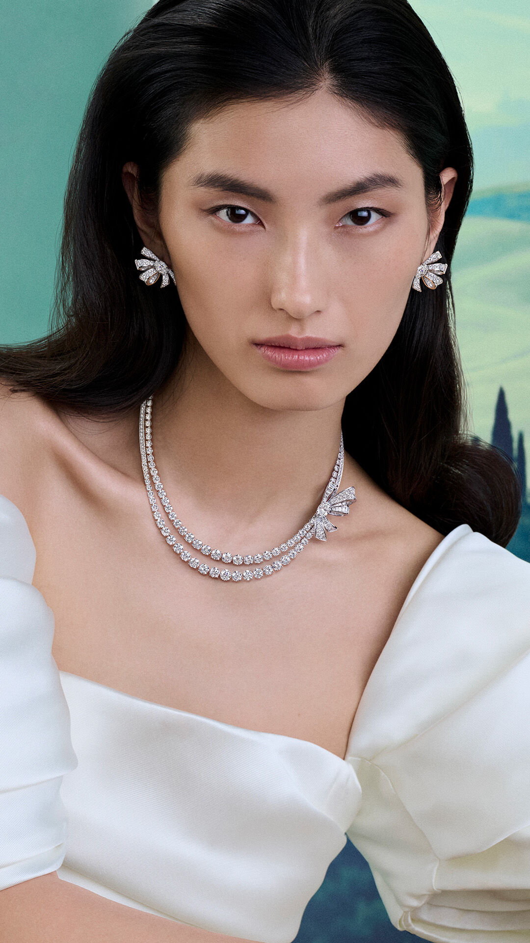 Tilda's Bow - image shows model wearing Graff Tilda's Bow white diamond necklace and earrings 