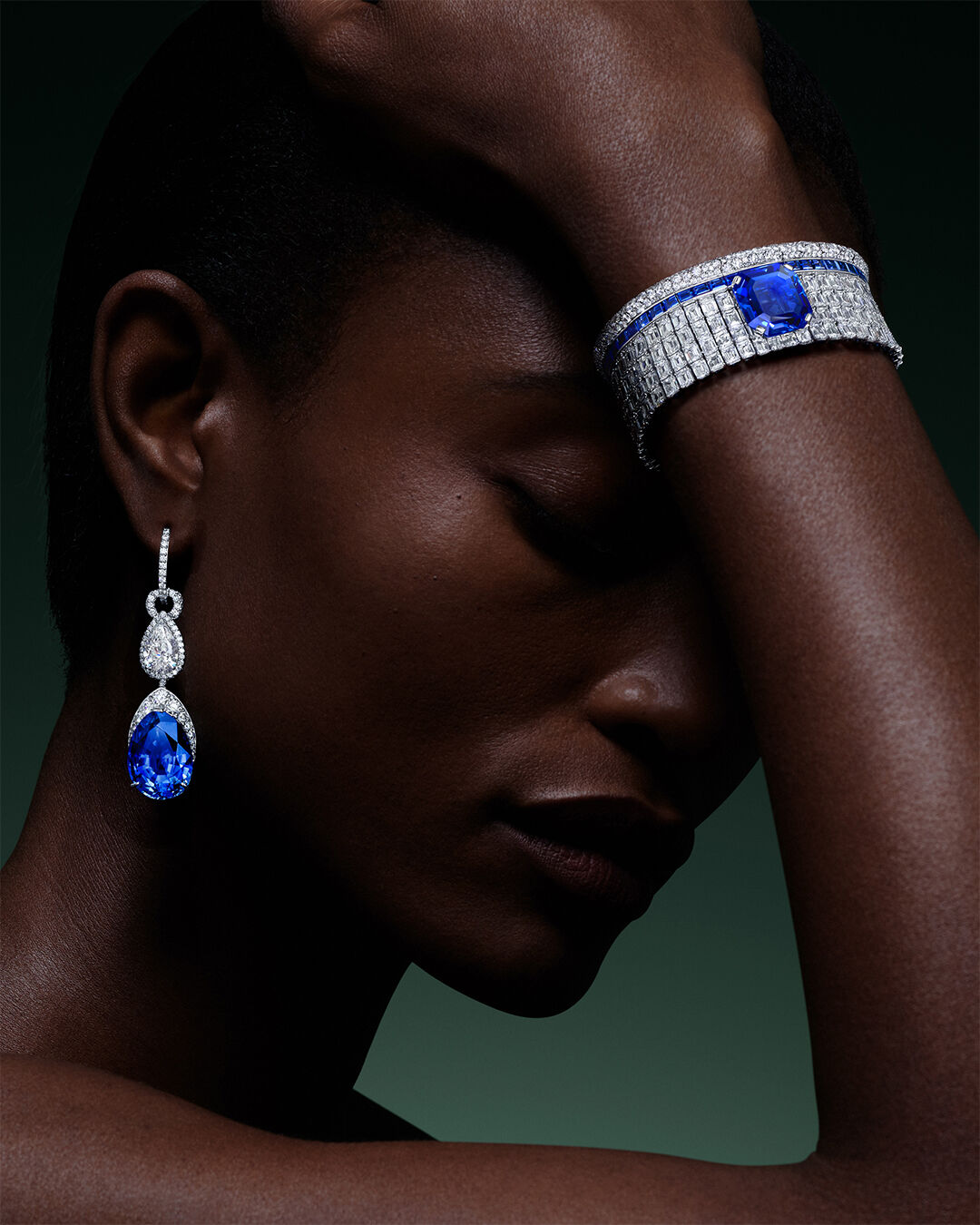 Image shows model wearing Graff Sapphire High Jewellery bangle and earrings 