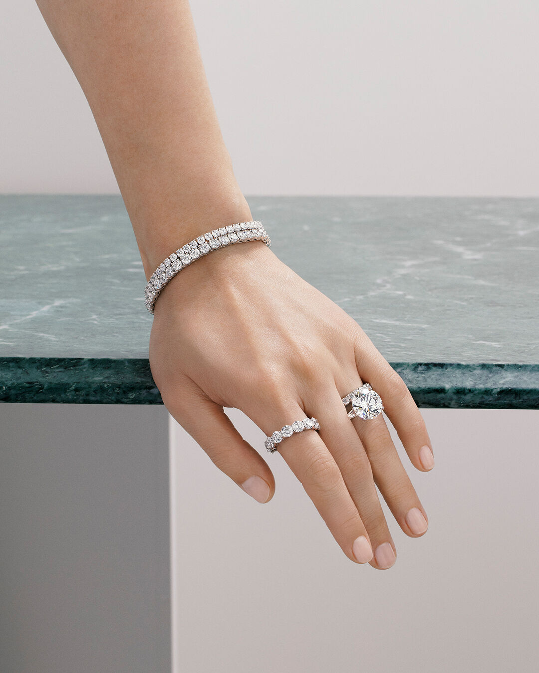Classic Graff - image shows model hand wearing Classic Graff White Diamond Rings and Bracelets 