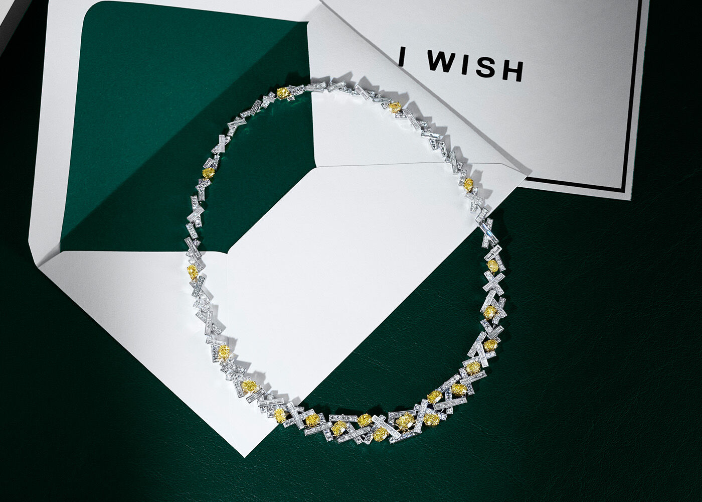 Graff Ultimate Gifts - Still life image of Graff Tilda's Bow Pave Diamond necklace pictured on top of Graff jewellery gift box