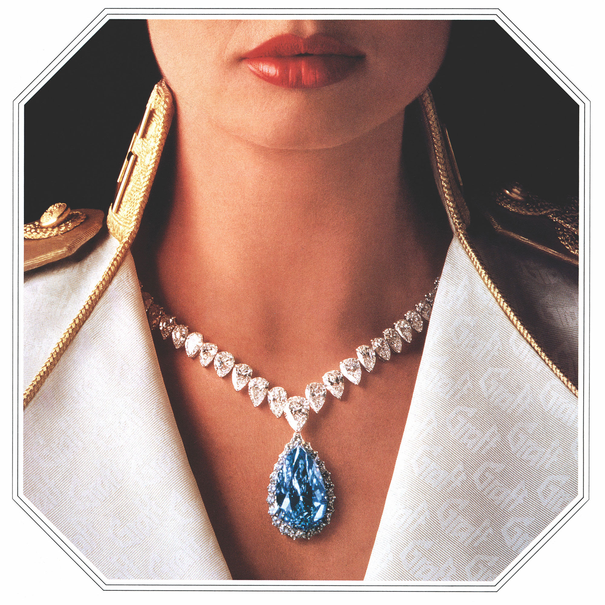 Model wearing a Graff high jewellery diamond necklace featuring pear shape blue diamond.