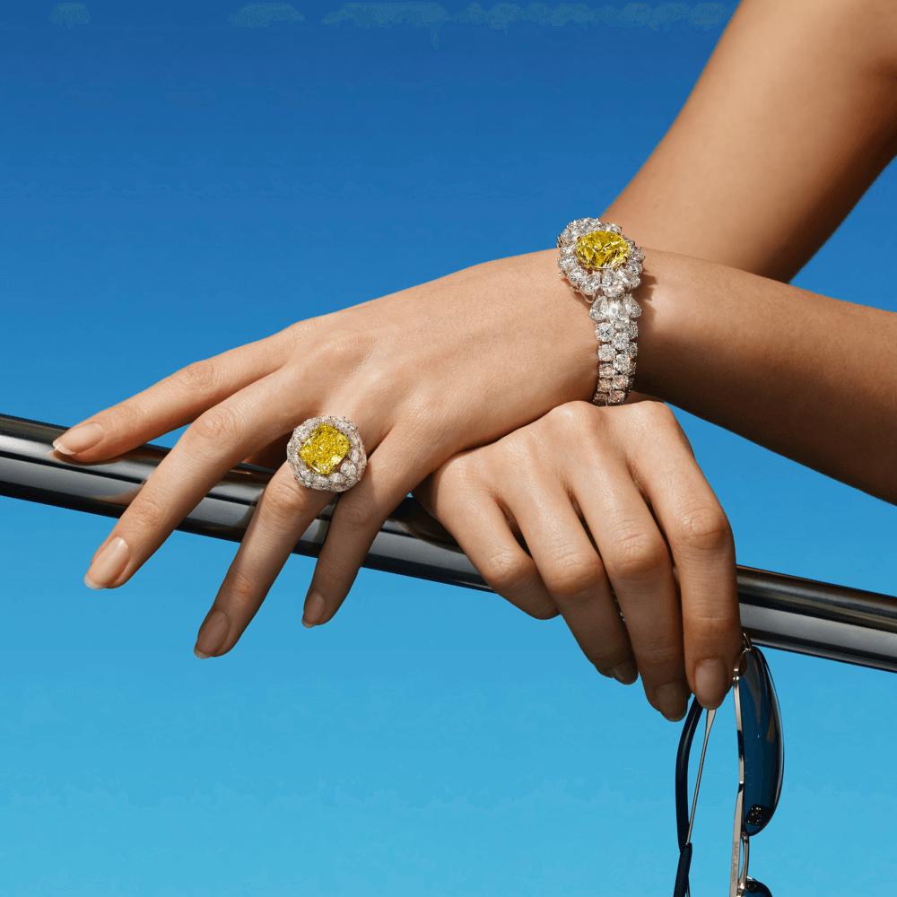 a lady on a boat wearing graff yellow diamond ring and bracelet
