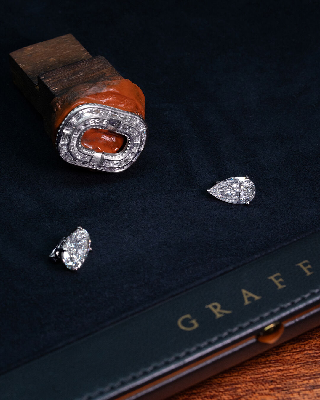 Image shows creation of Graff diamond and emerald high jewellery bangle in workshop