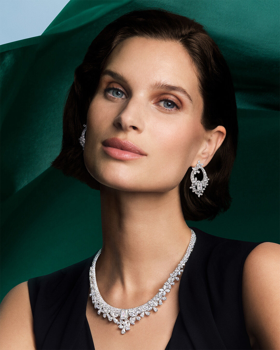 Image shows model wearing Graff Butterfly White Diamond High Jewellery necklace and earrings