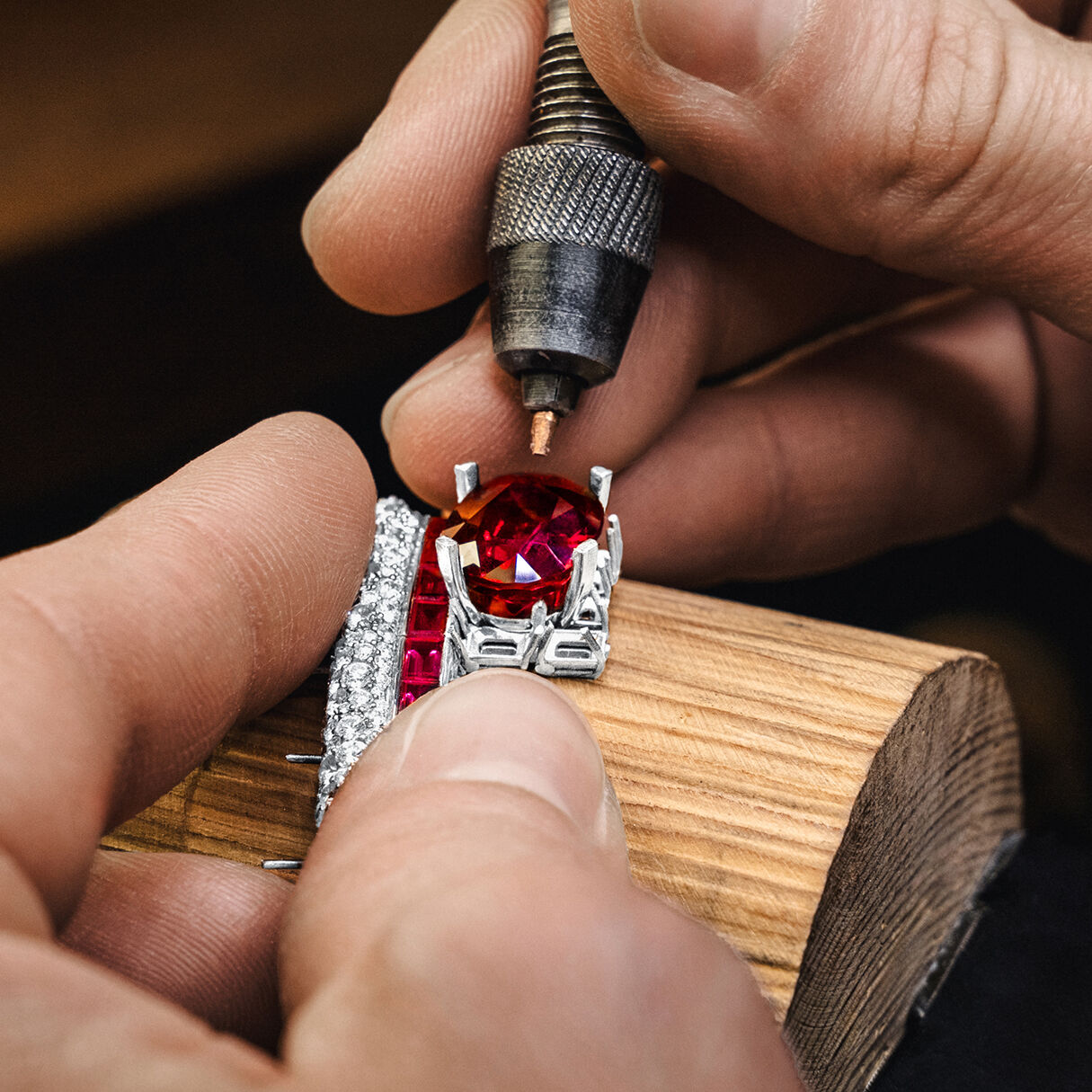 Ruby gemstone being set in Ruby and White Diamond High Jewellery bangle by Graff craftsman
