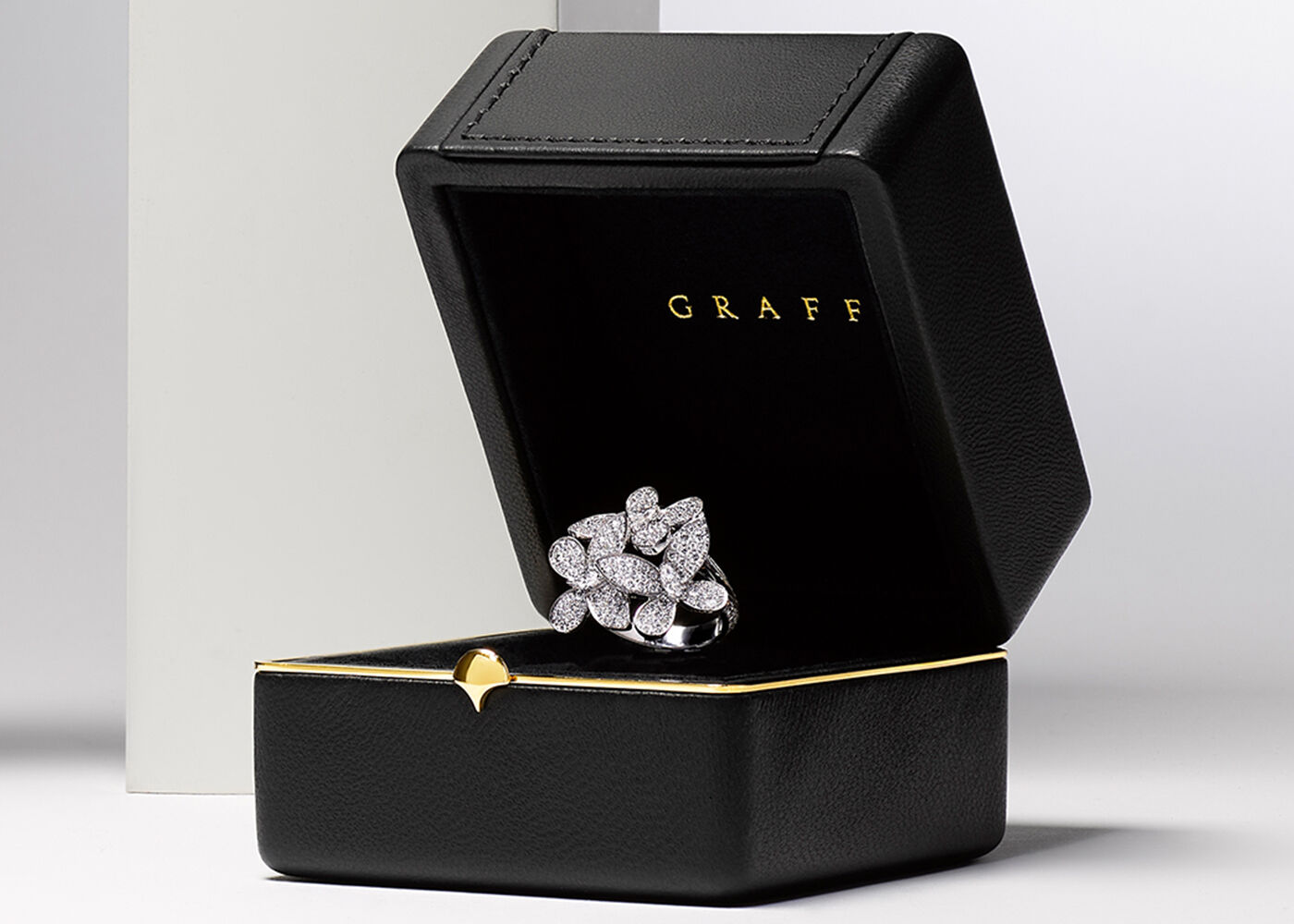 Valentine's Day Gifts - Image shows models holding hands wearing Laurence Graff Signature collection Rings and Bangles