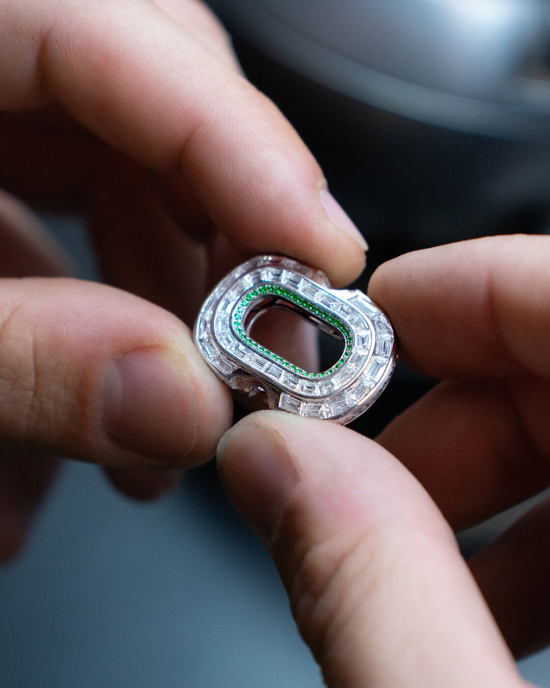 Image shows creation of Graff diamond and emerald high jewellery bangle in workshop