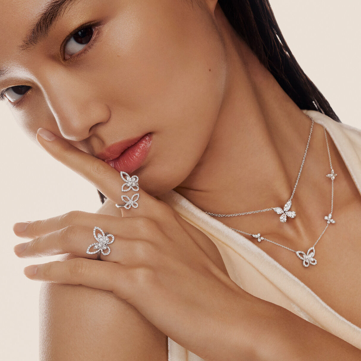 Model wearing Graff Diamond Butterfly Collection Necklaces and Rings