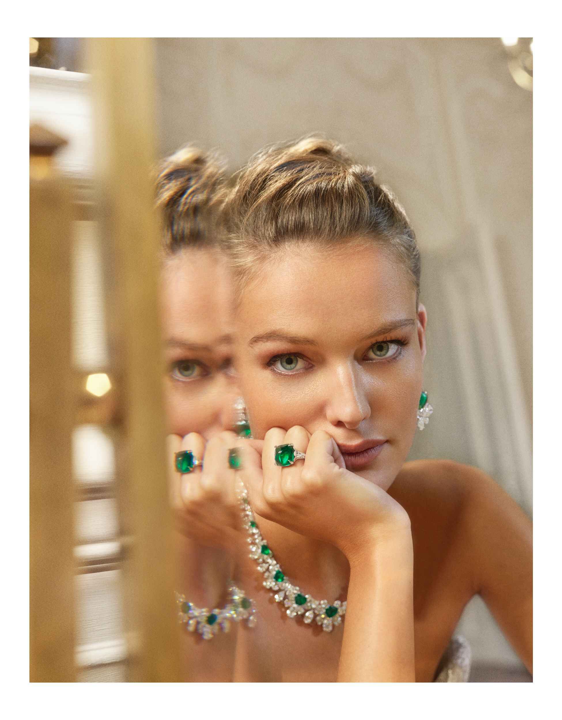 Model wearing Graff's high jewellery emerald necklace, ring and earrings