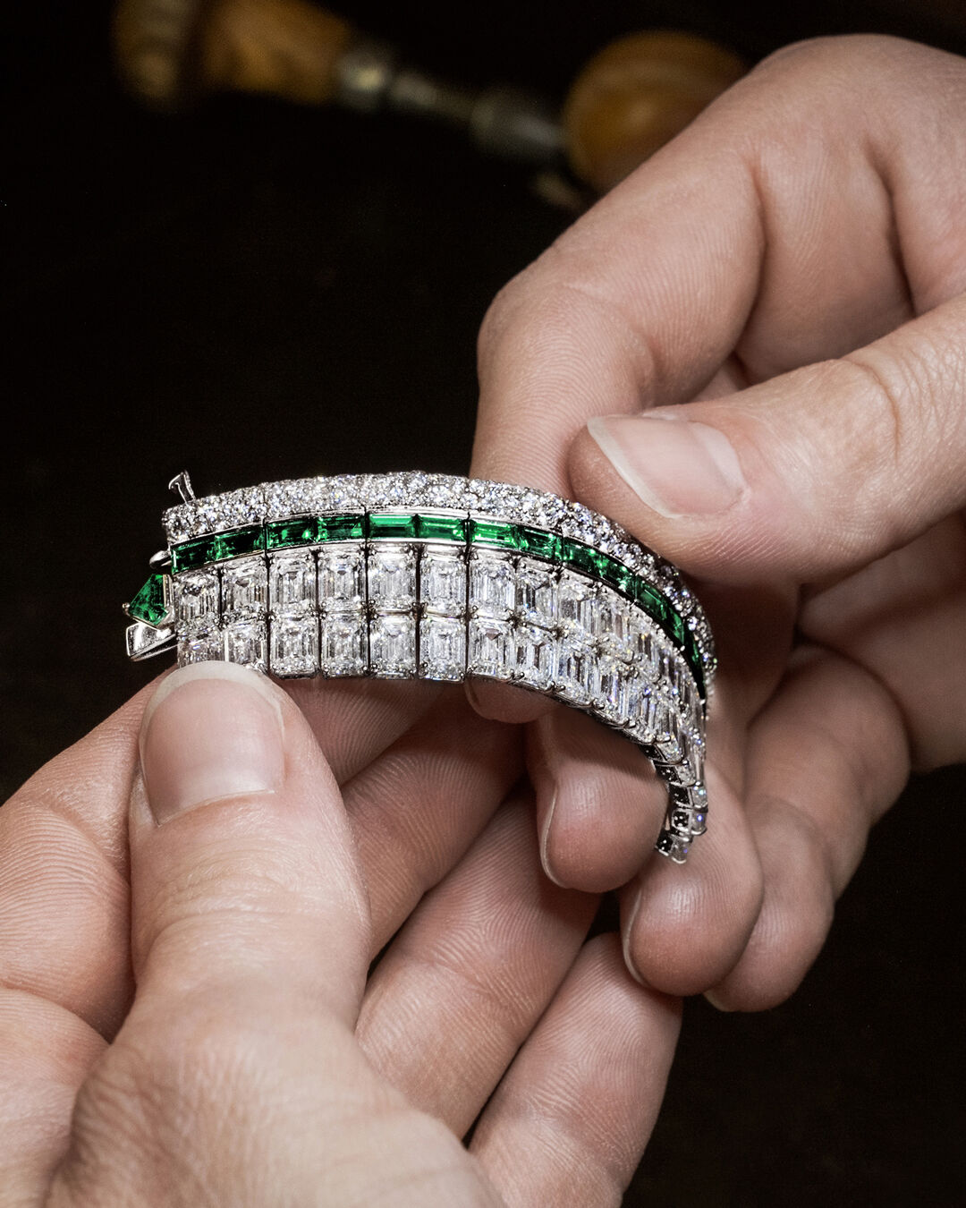 Image shows Graff Emerald and White Diamond High Jewellery bangle being created in Graff workshop