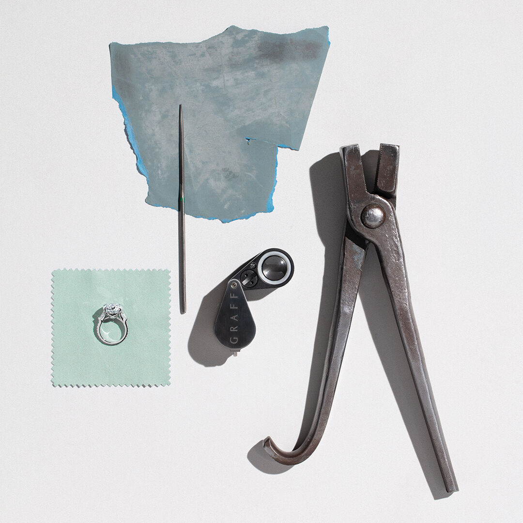 Guide to diamond certification - image shows Graff diamond engagement ring and workshop tools