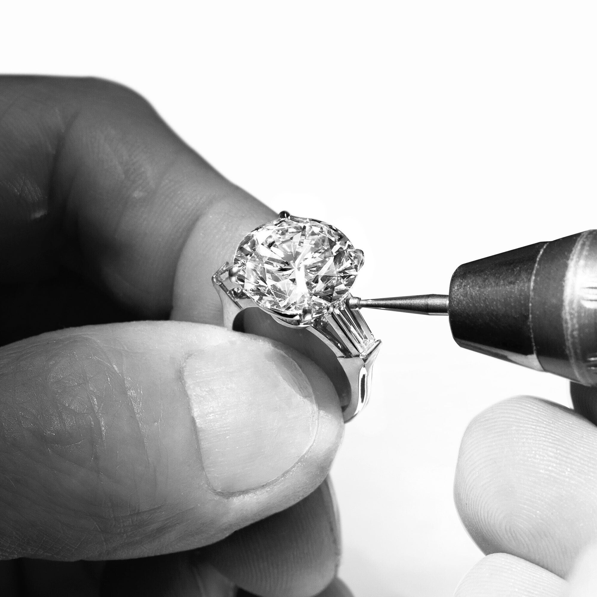 Close up of a Graff craftsman setting a diamond ring