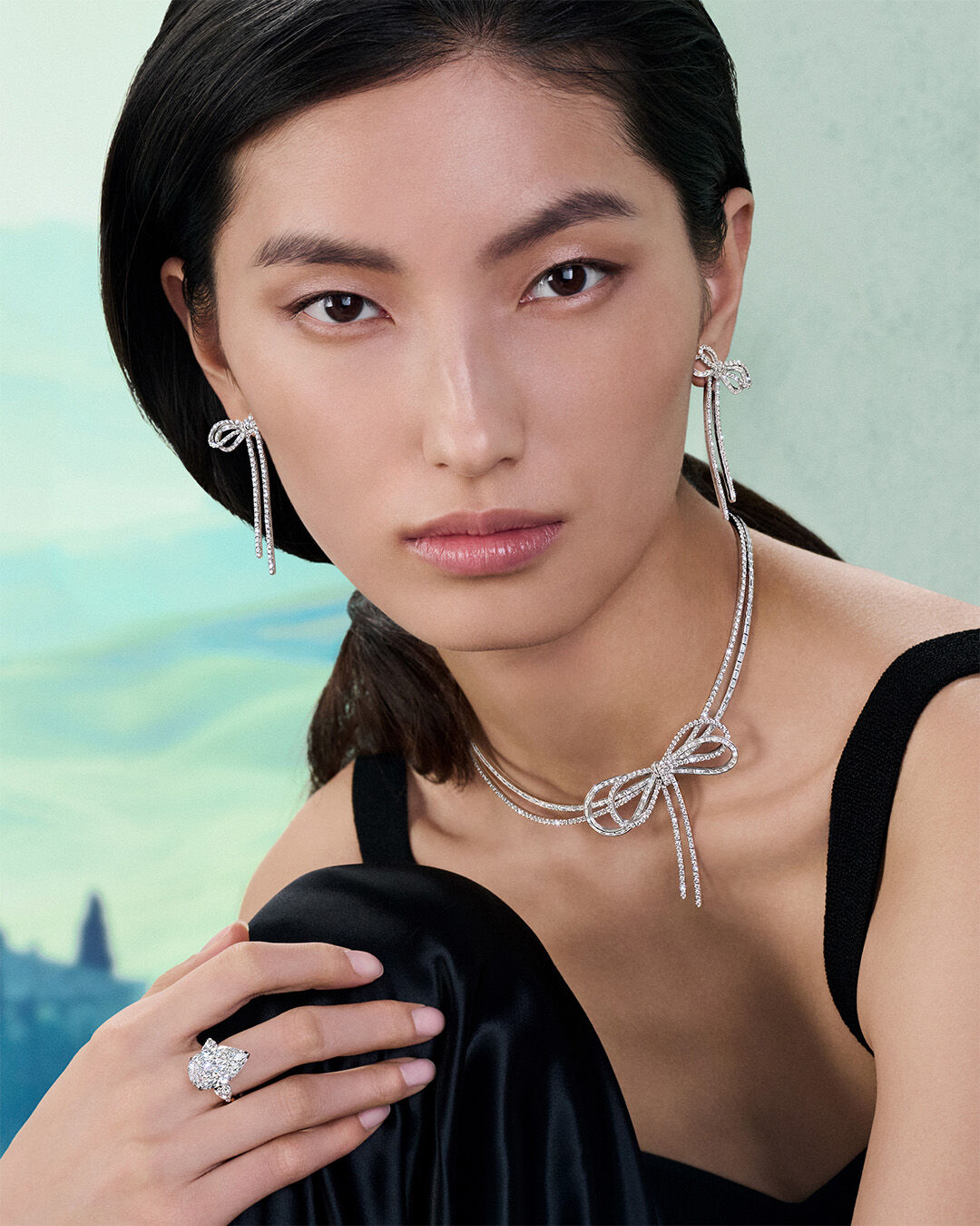 Image of model hands wearing Graff Tilda's Bow ring and bracelet 