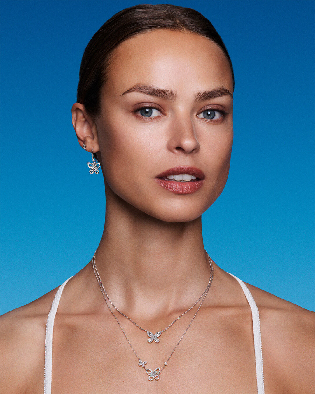 Image shows model wearing Graff Butterfly Collection diamond jewellery