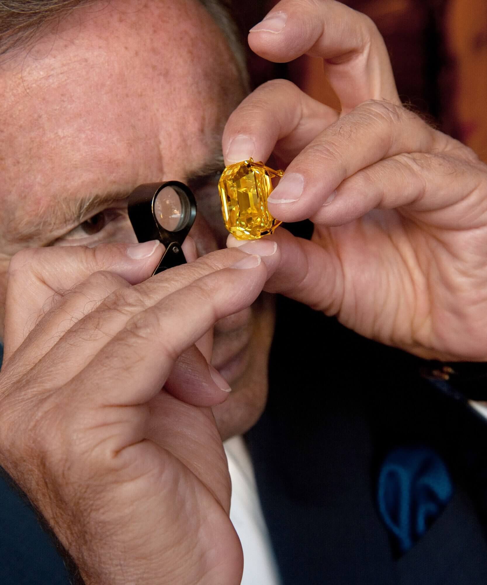 Laurence Graff inspecting a yellow diamond