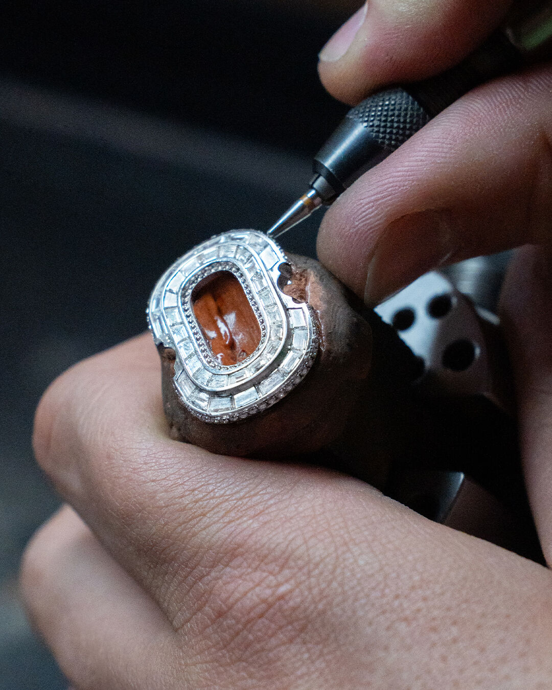 Image shows creation of Graff diamond and emerald high jewellery bangle in workshop