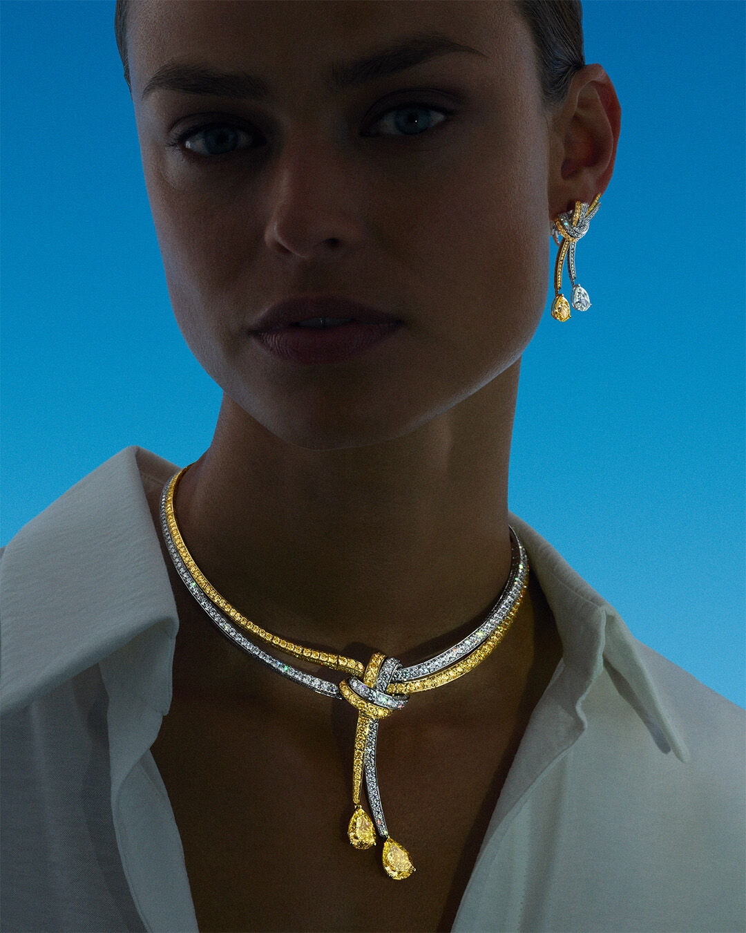 Image shows model wearing Tilda's Bow High Jewellery Yellow and White Diamond Necklace