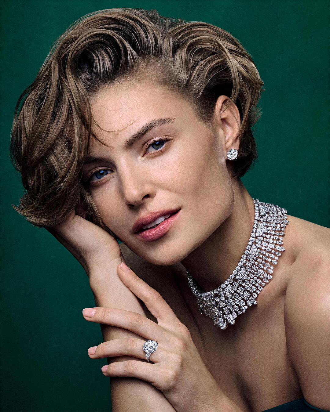 Image shows model wearing Graff White Diamond High Jewellery necklace, earrings and ring