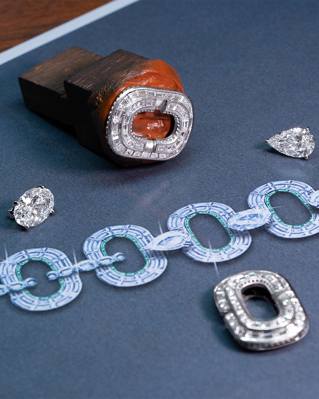 Image shows creation of Graff diamond and emerald high jewellery bangle in workshop