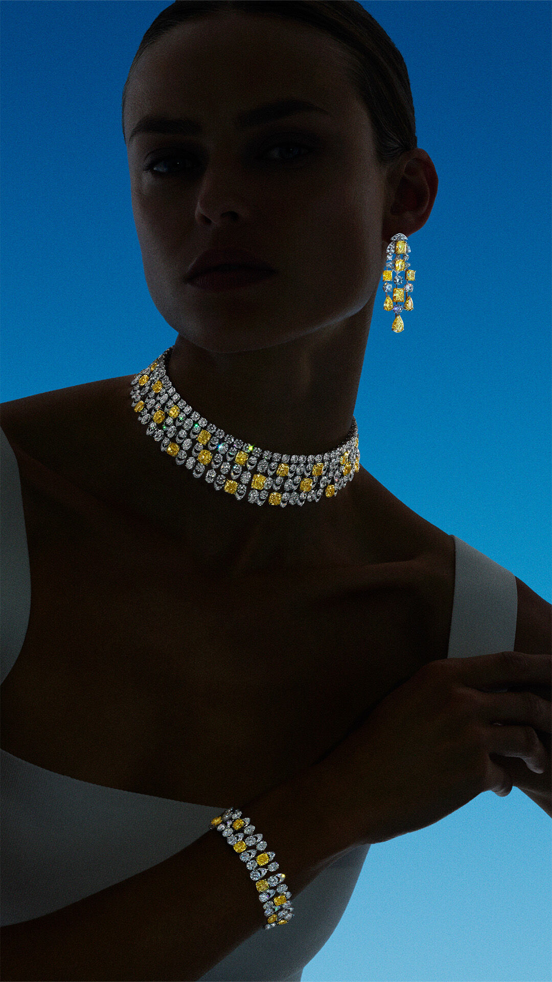 Image shows model wearing Graff Yellow and White Diamond High Jewellery earrings