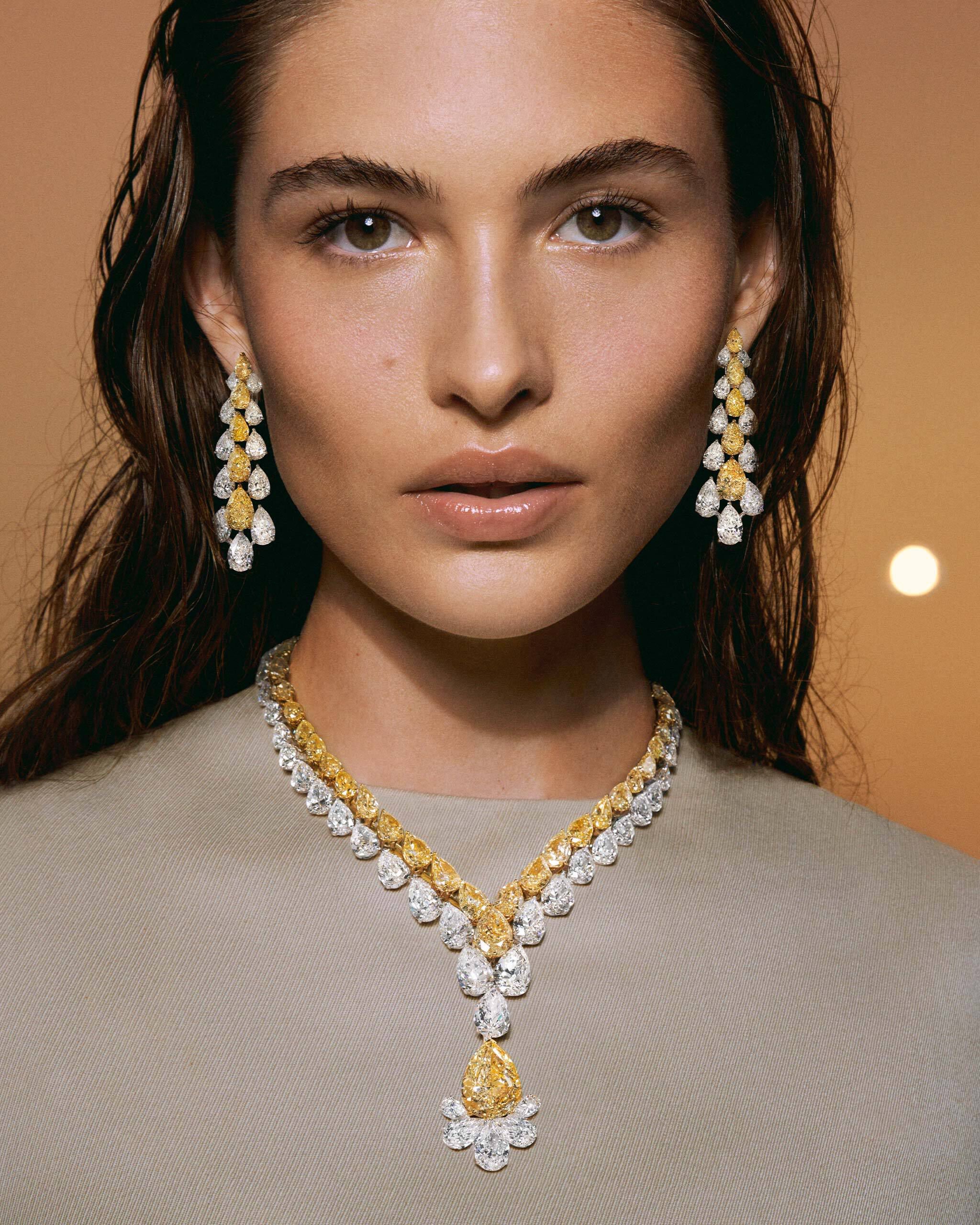 Model wears Graff High Jewellery White Diamond and Yellow Diamond earrings and necklace
