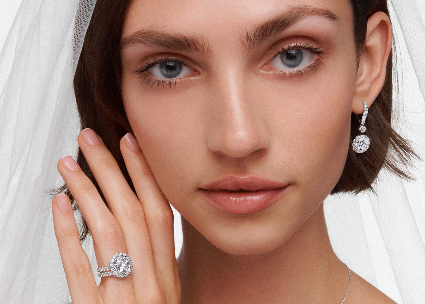 Model wears Graff Icon Round Engagement Ring, Diamond Wedding Band and Icon Round Diamond Earrings