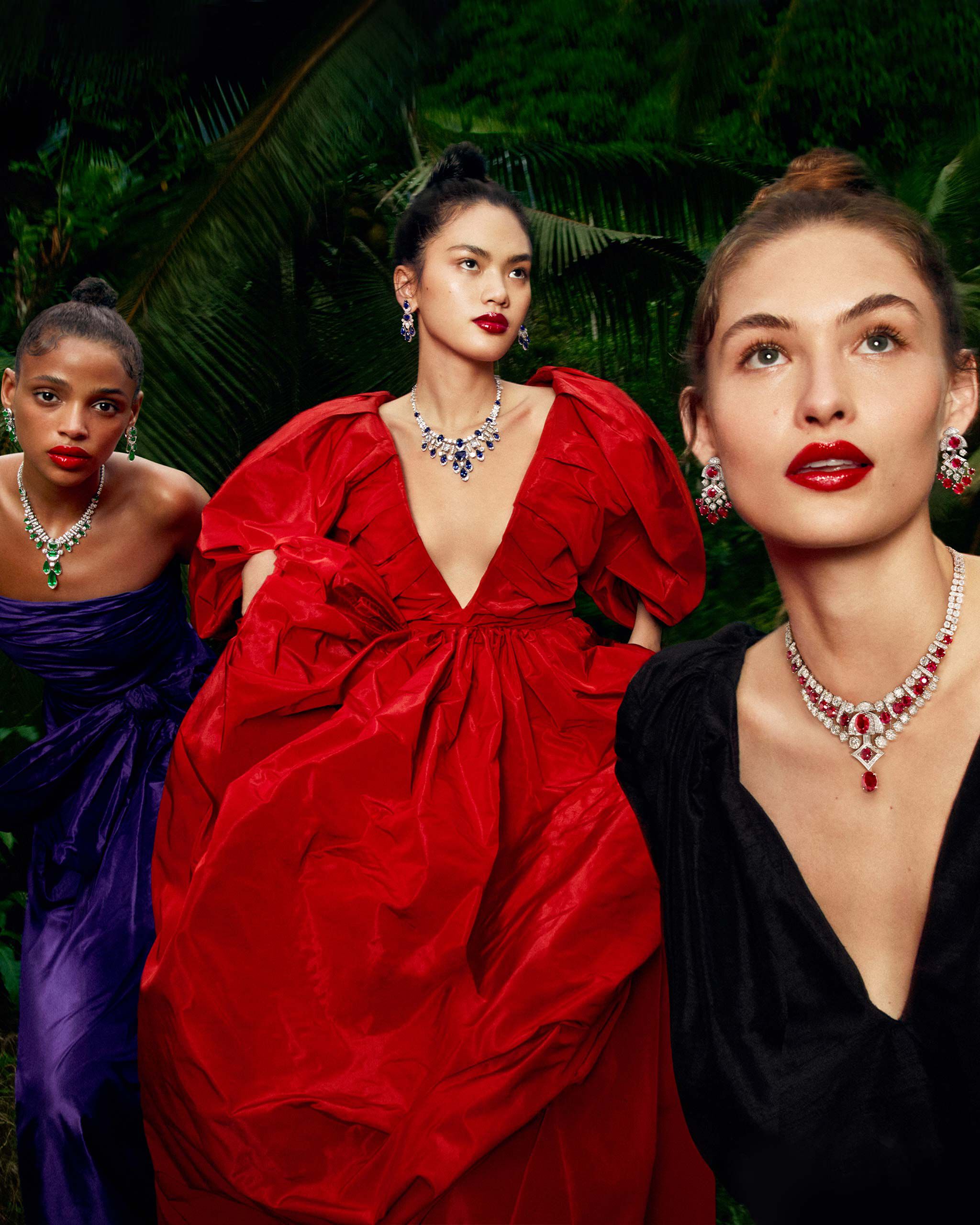 Three models wear Graff High Jewellery Emerald and White Diamond, Sapphire and White Diamond and Ruby and White Diamond necklaces and earrings.