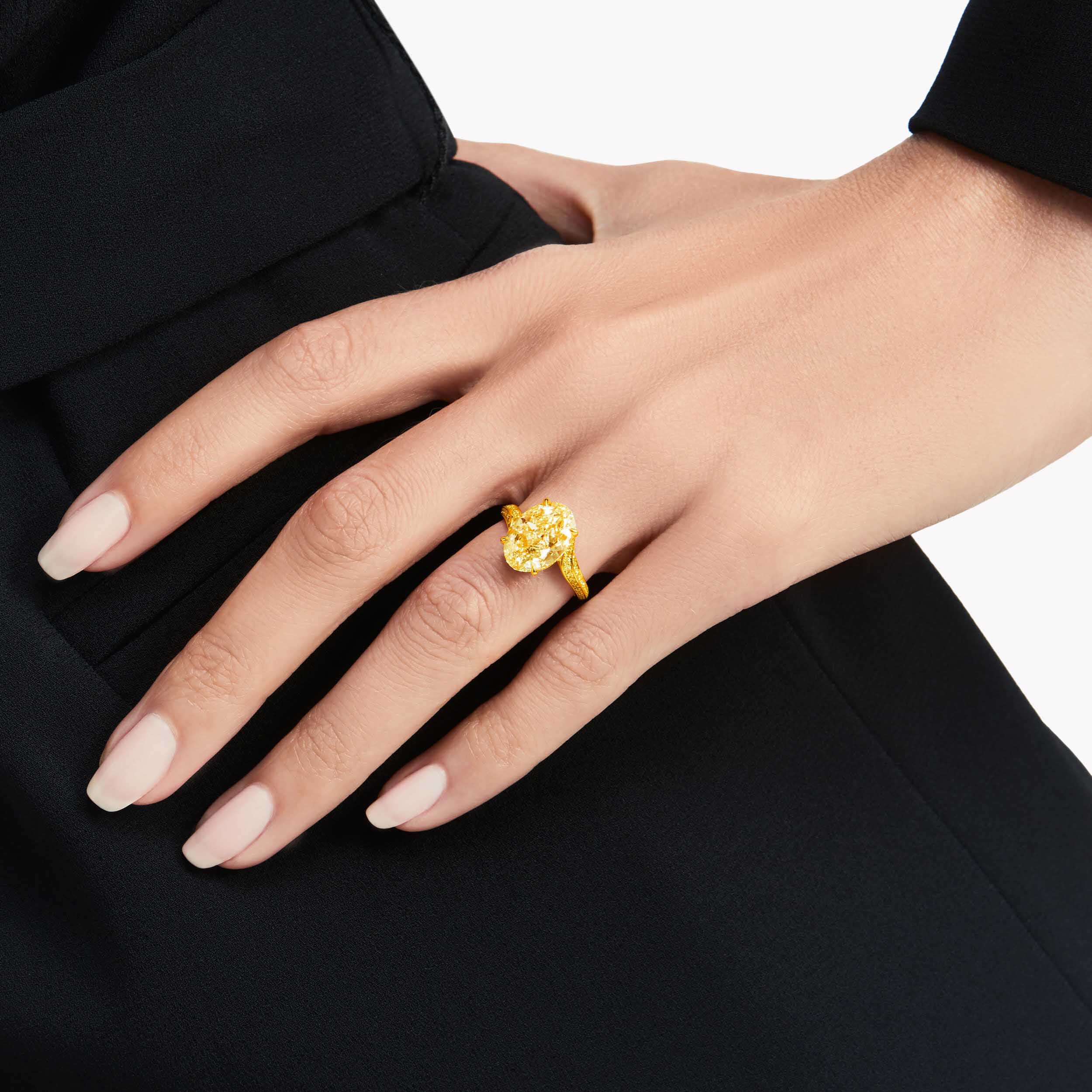 Model wearing a Graff oval yellow diamond unique solitaire ring
