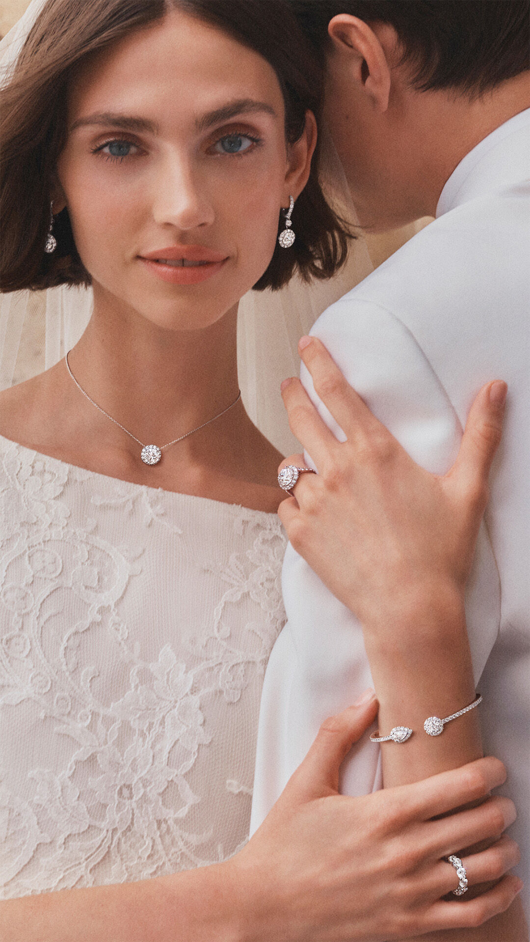 image shows models wearing Graff diamond bridal jewellery