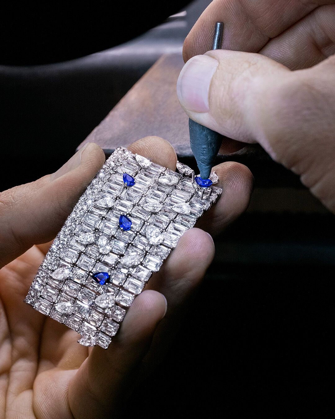 Image shows Graff sapphire and white diamond high jewellery necklace being constructed in Graff workshop