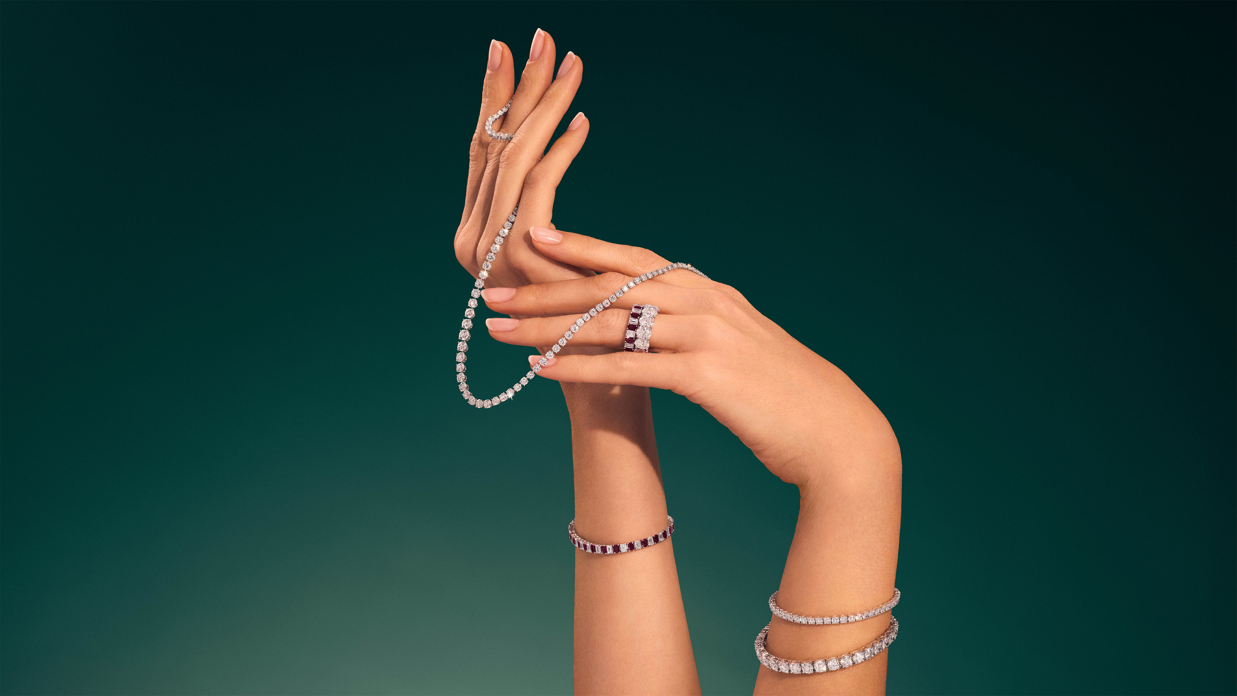 Image shows model hand image wearing Graff Emerald Cut solitaire ring and Diamond line tennis bracelet