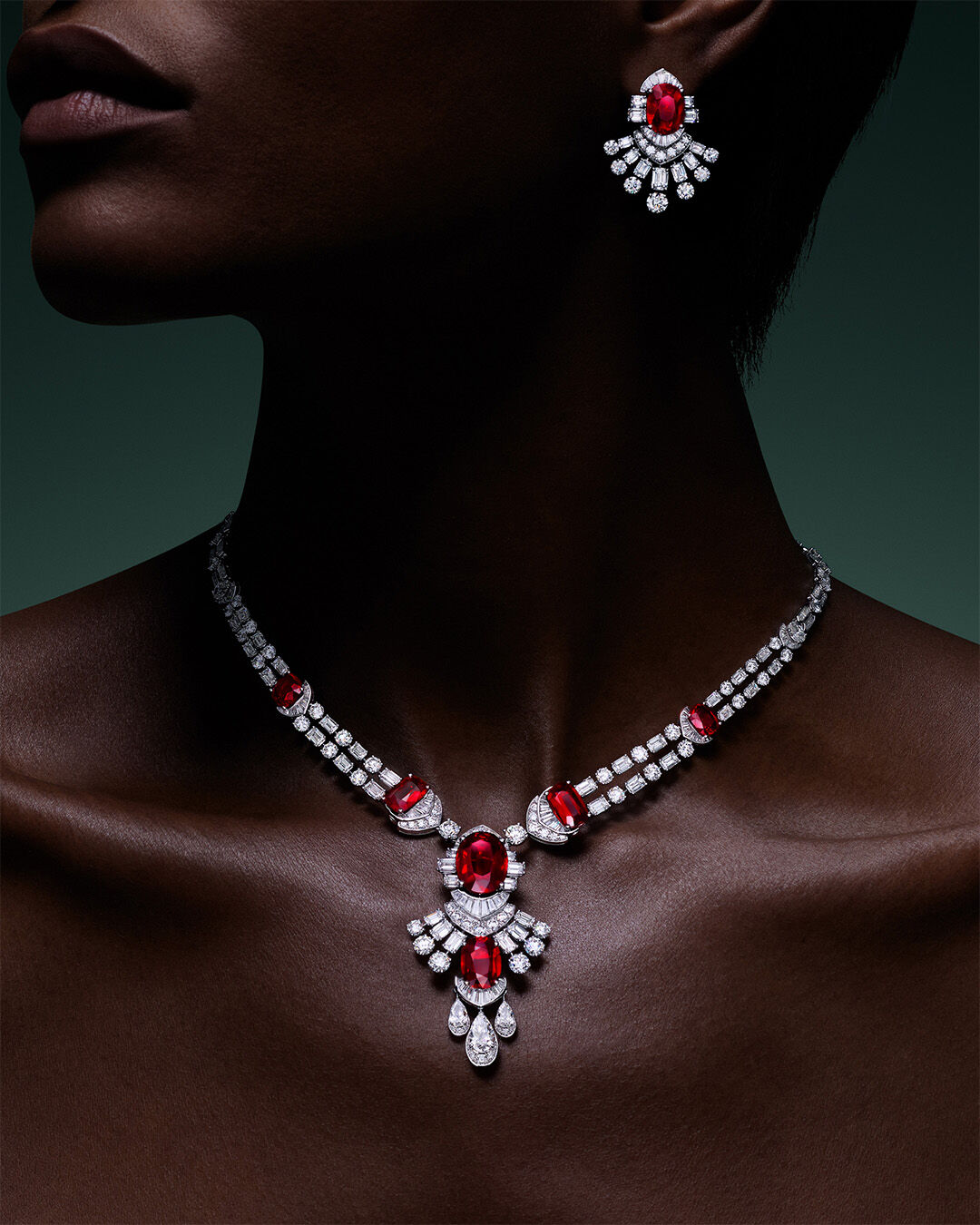 Image shows model wearing Graff Ruby and White Diamond High Jewellery necklace and earrings