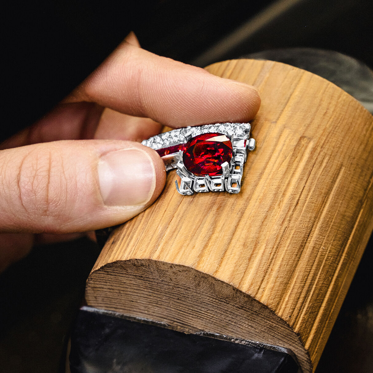 Graff craftsman holding Ruby and White Diamond High Jewellery bangle in Graff workshop