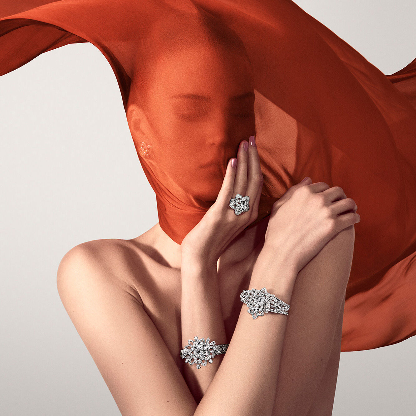 Model with orange scarf wears Graff Unique Timepieces and Graff diamond ring