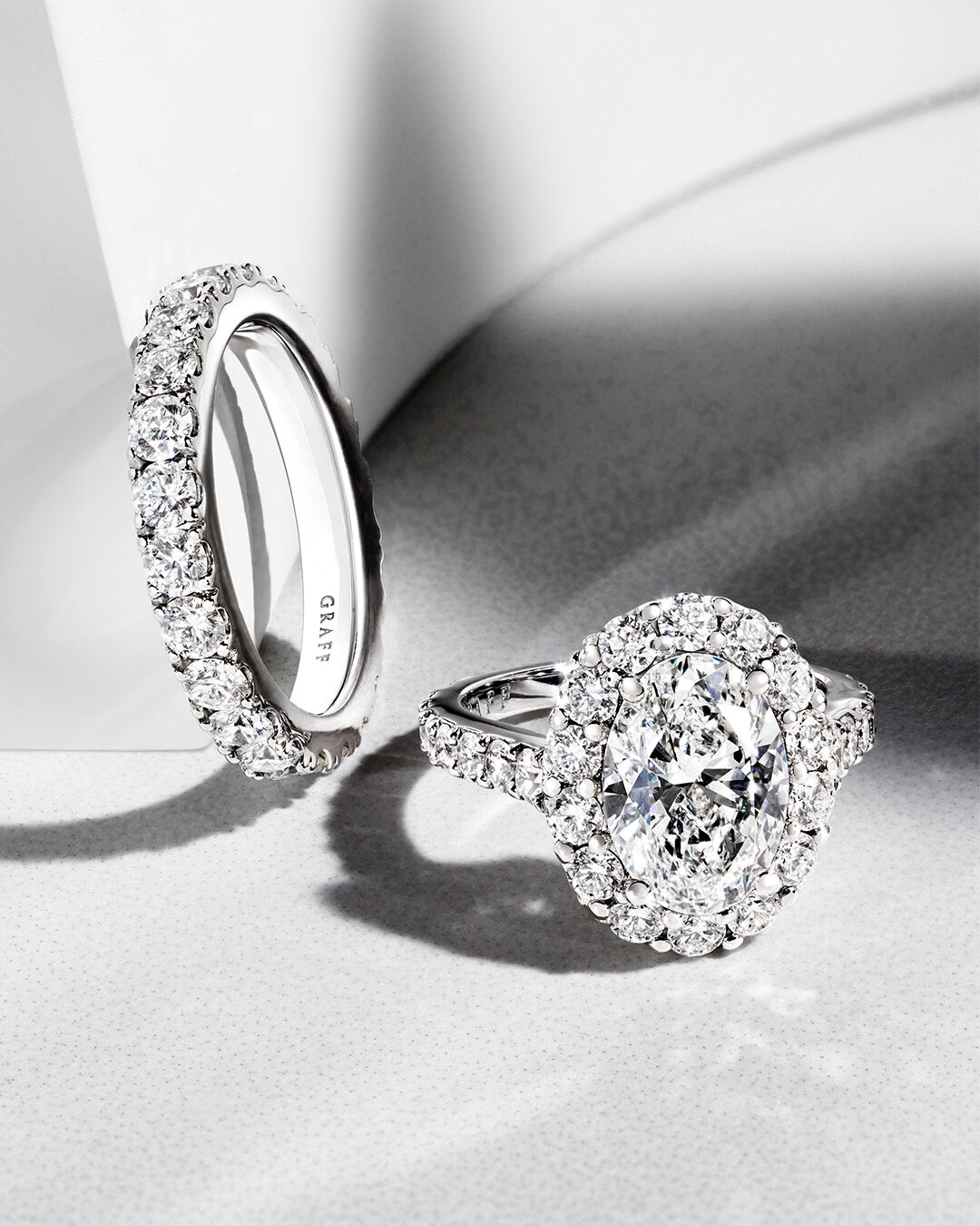 Image shows Graff Oval Diamond engagement ring and Graff round diamond wedding band 