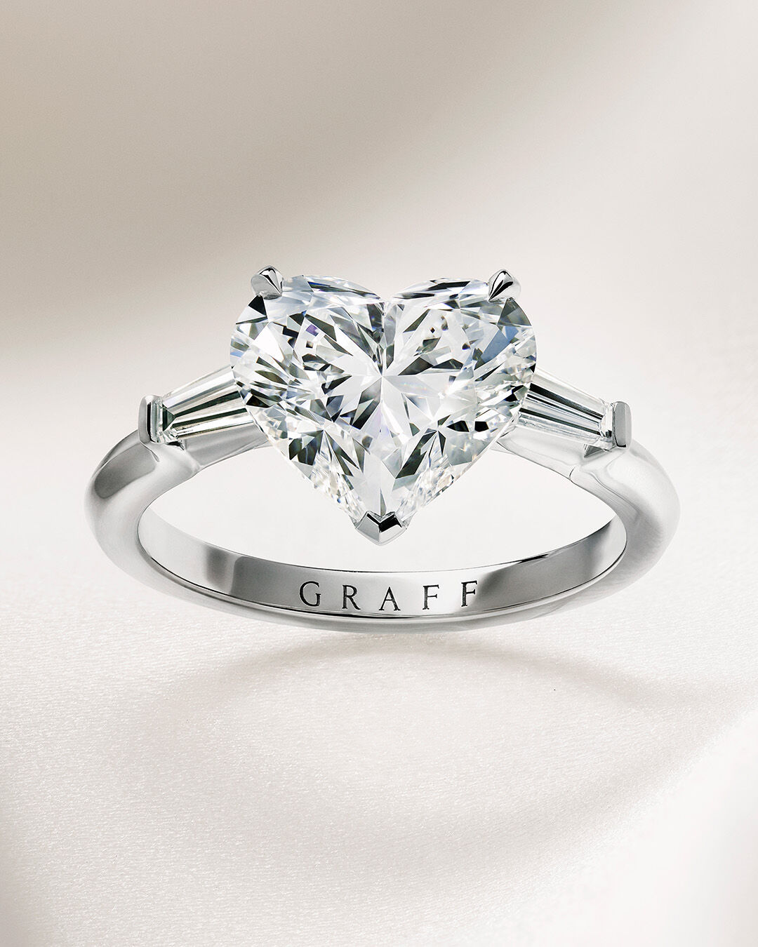 Image shows Graff Oval Diamond engagement ring and Graff round diamond wedding band 