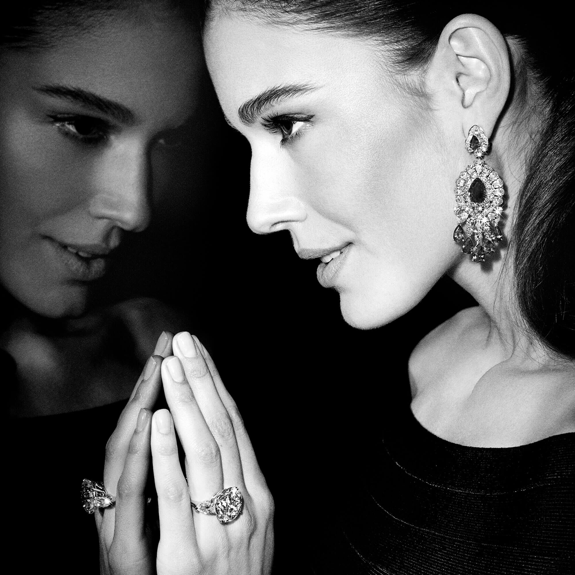 Model wearing Graff high jewellery earrings and an engagement ring.