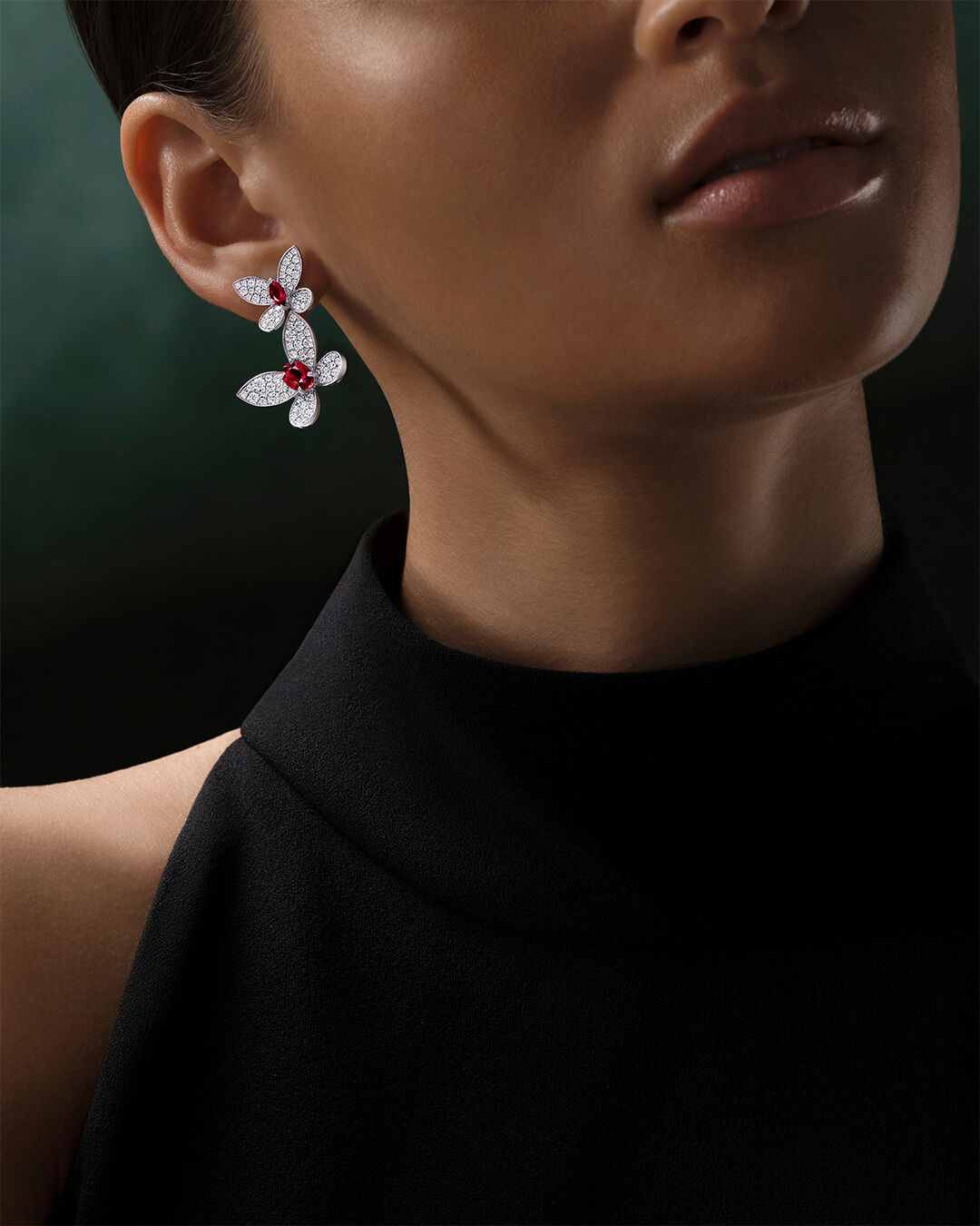 Image shows model wearing Graff Butterfly diamond and ruby earrings
