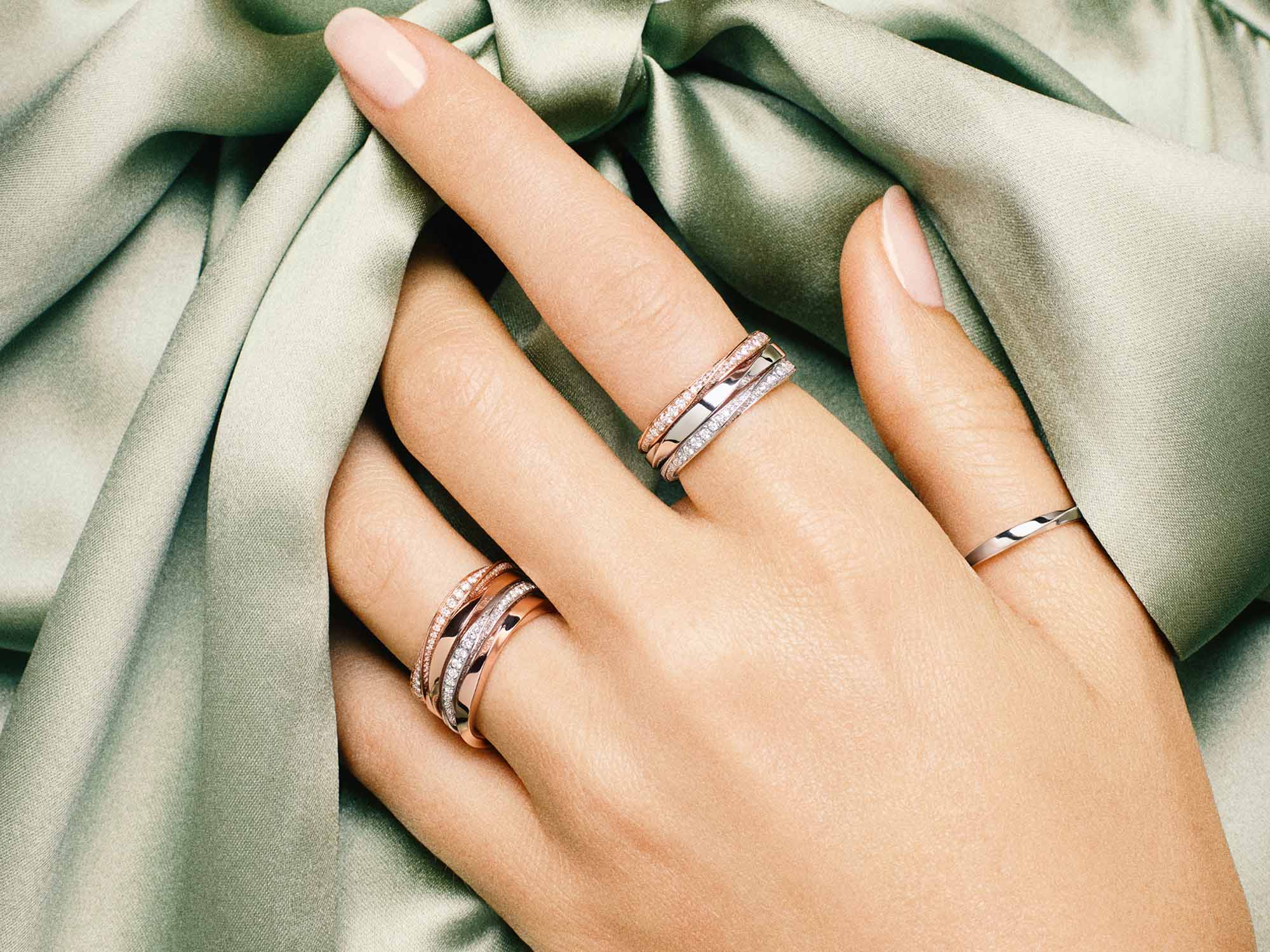 Model's hand with Spiral Pavé Diamond Band and Spiral Band from the Graff Spiral Jewellery Collection
