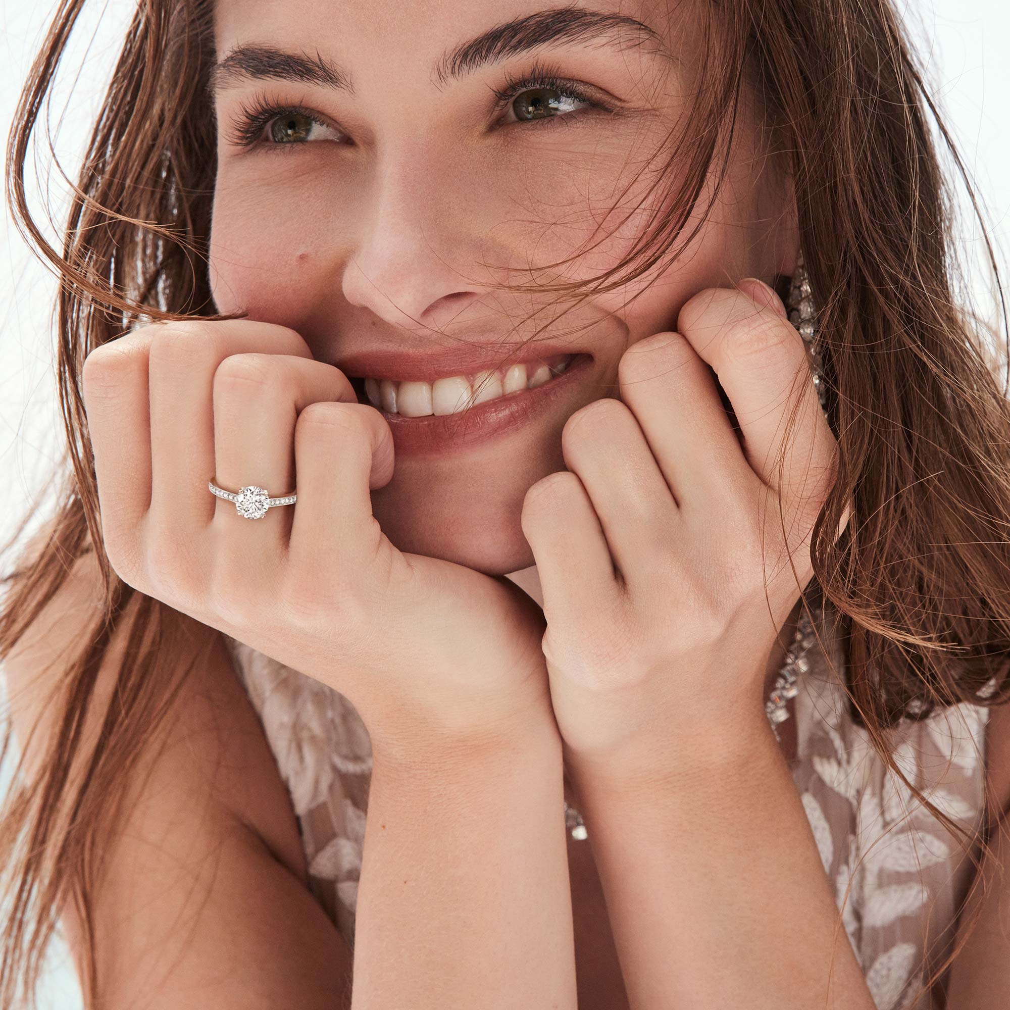 Model wears Graff Carissa Diamond Drop Earrings, round Diamond Solitaire and Castle Set Round Diamond Wedding Band.