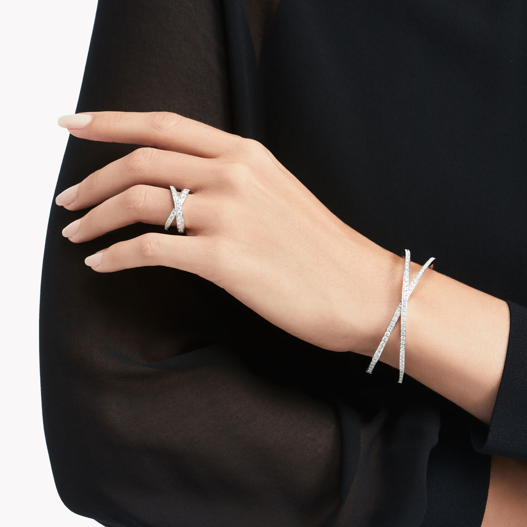 Model's hand showing Kiss Pavé Diamond Bangle and Kiss Pavé Diamond Ring and Kiss Pavé Diamond Ring from the Graff Spiral Jewellery Collection